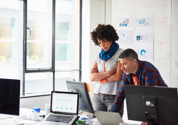 Woman at a desk looking at an ipad