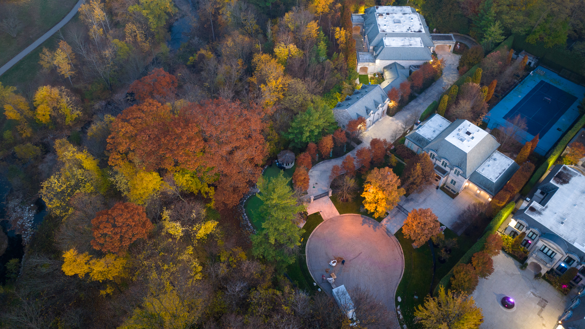 aerial view of homes and trees with autumn leaves