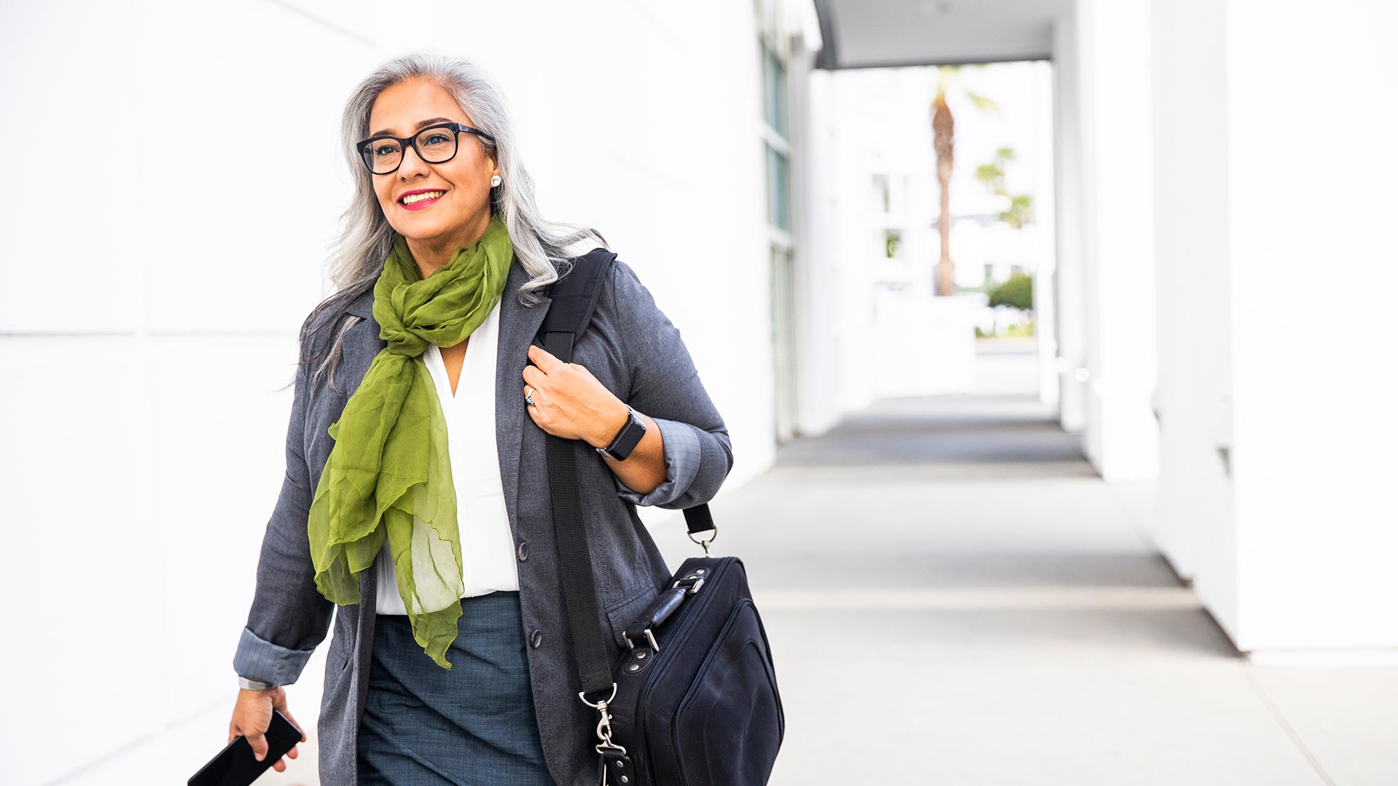 Woman walking carrying laptop bag