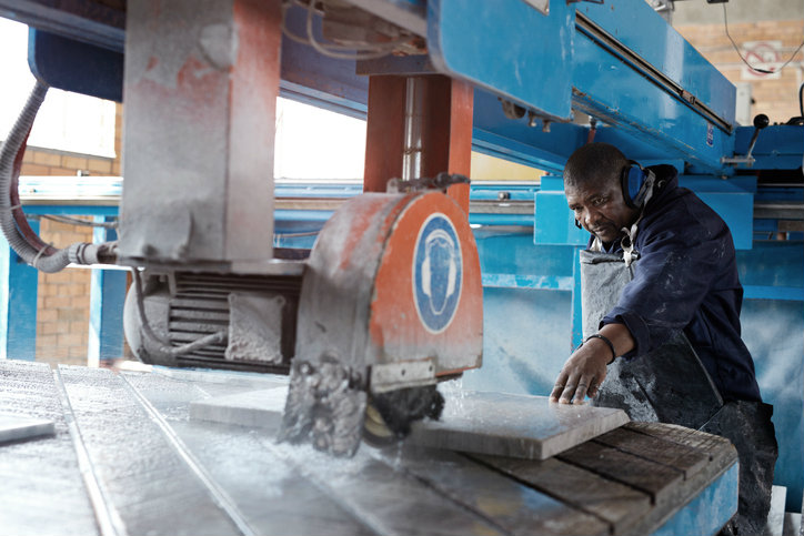 Man cutting marble slab