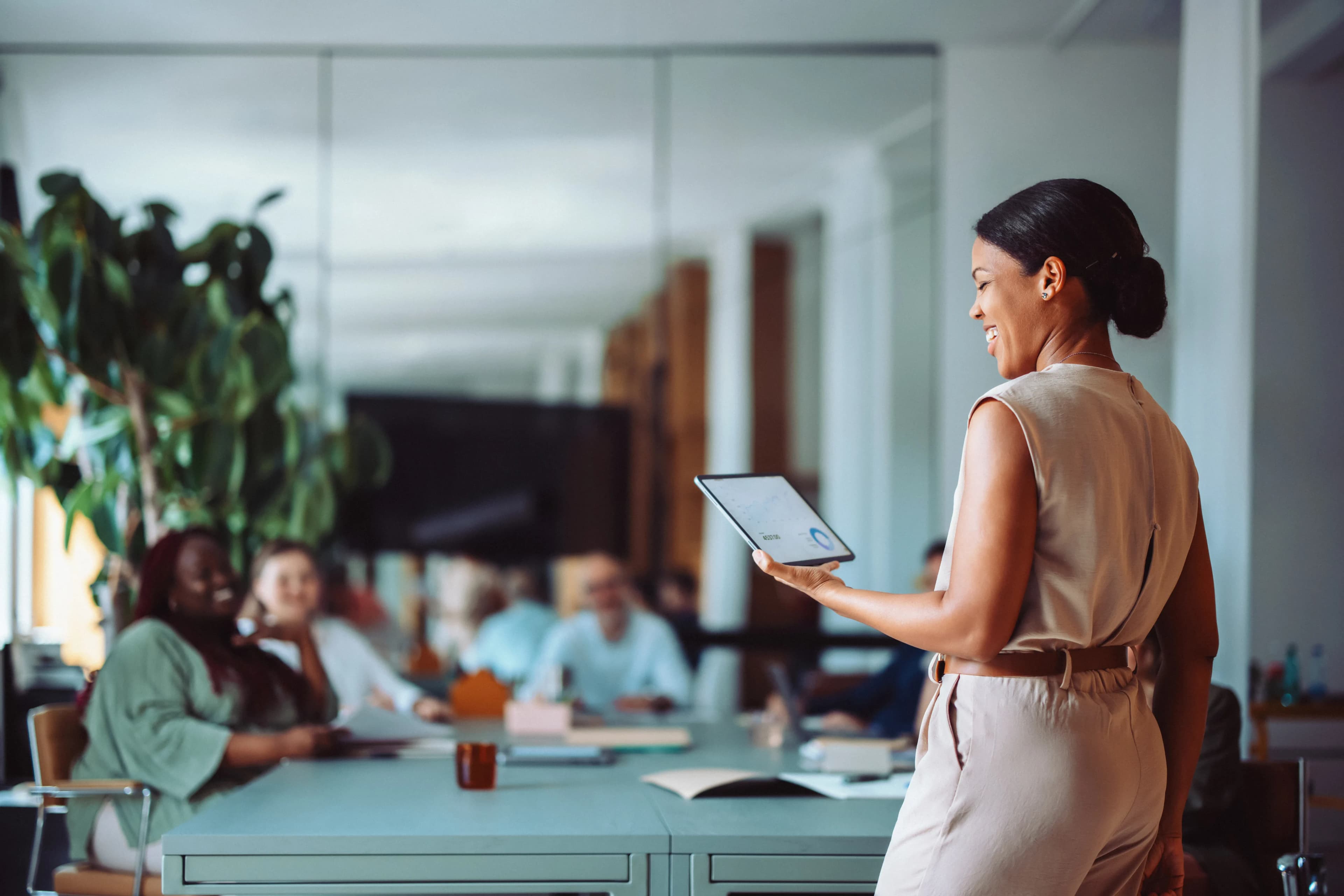 woman-presenting-tablet-meeting
