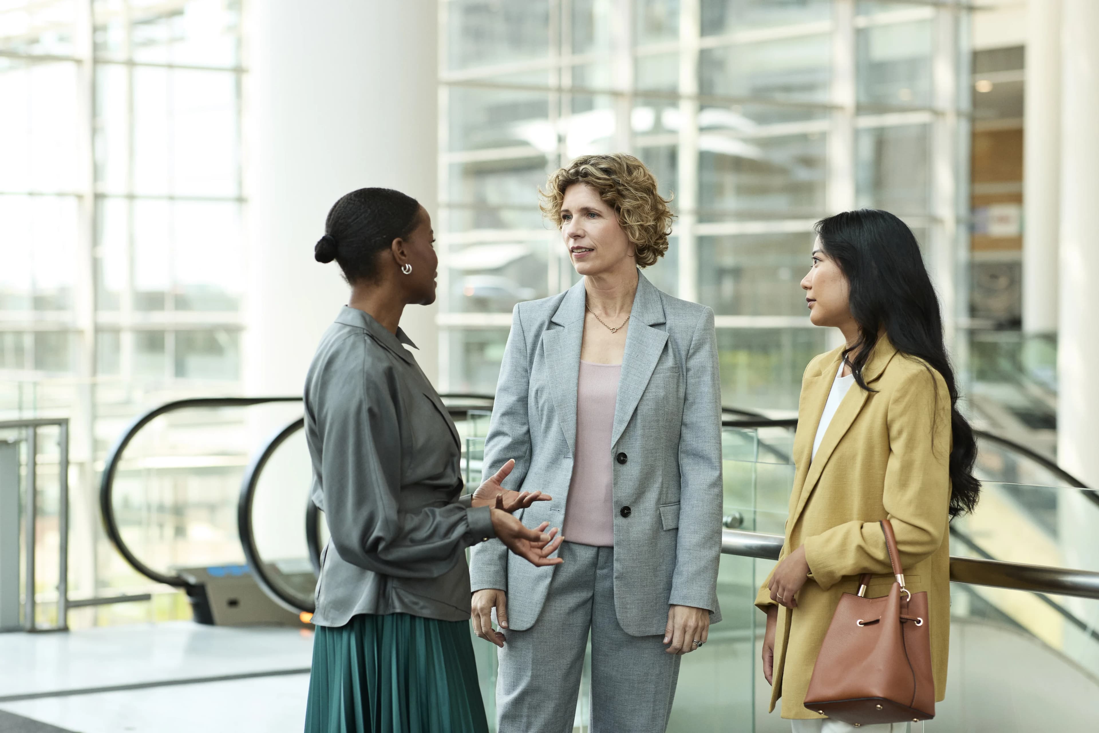 colleagues-talking-office-atrium