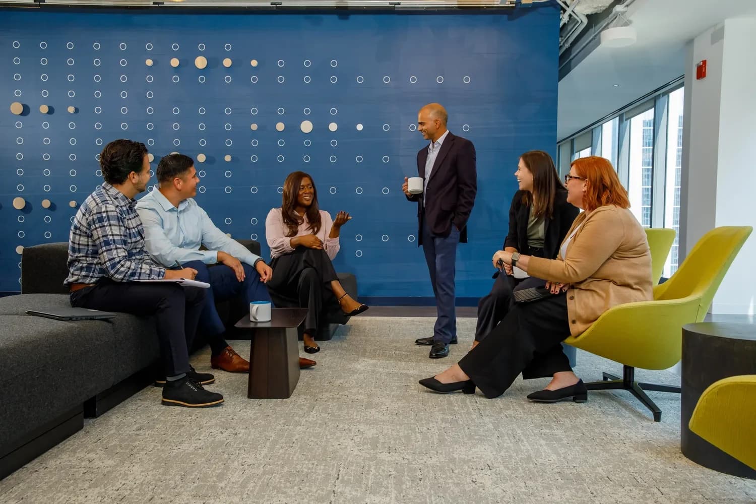 colleagues-chatting-in-office-lounge