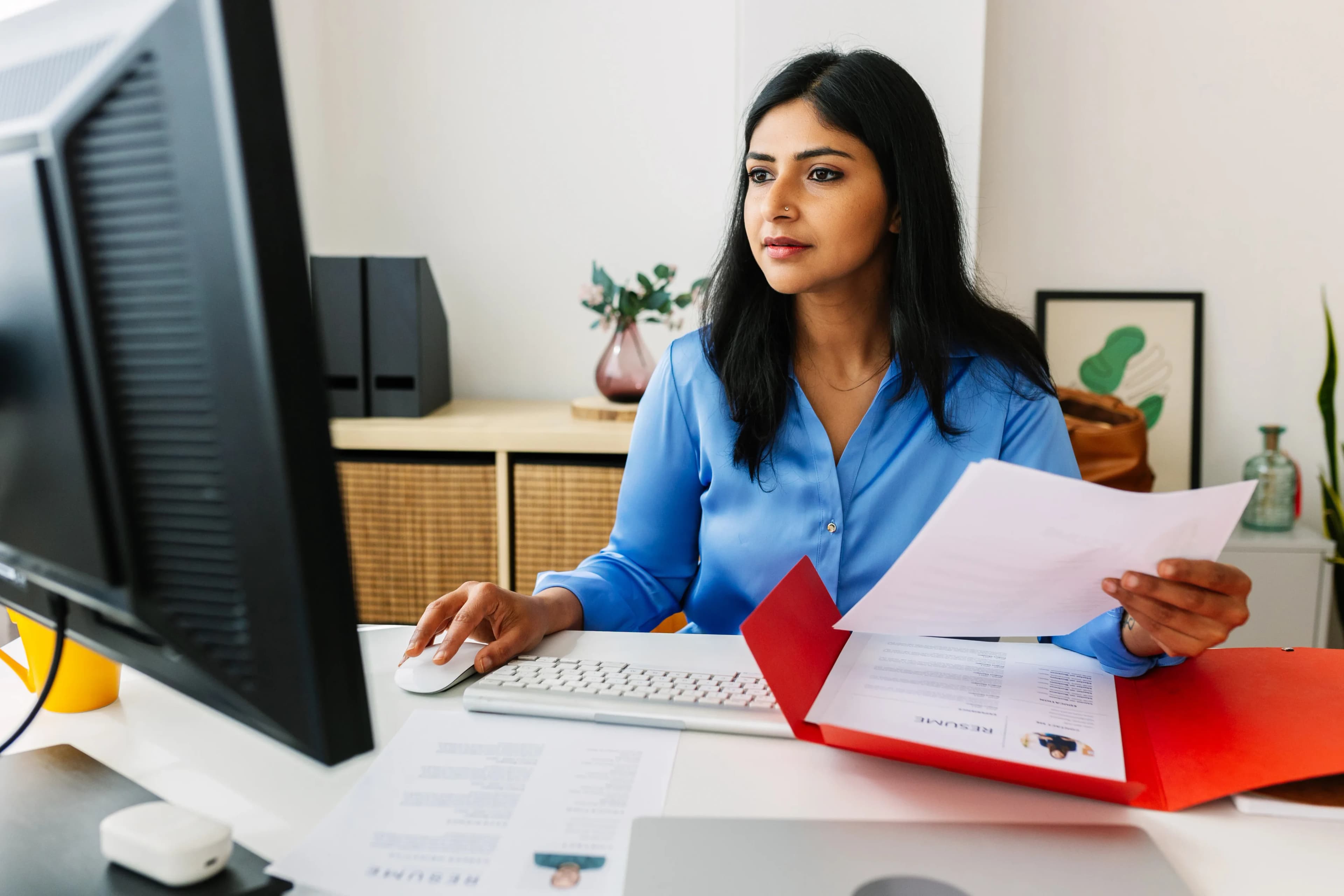 woman-reviewing-paperwork-desk