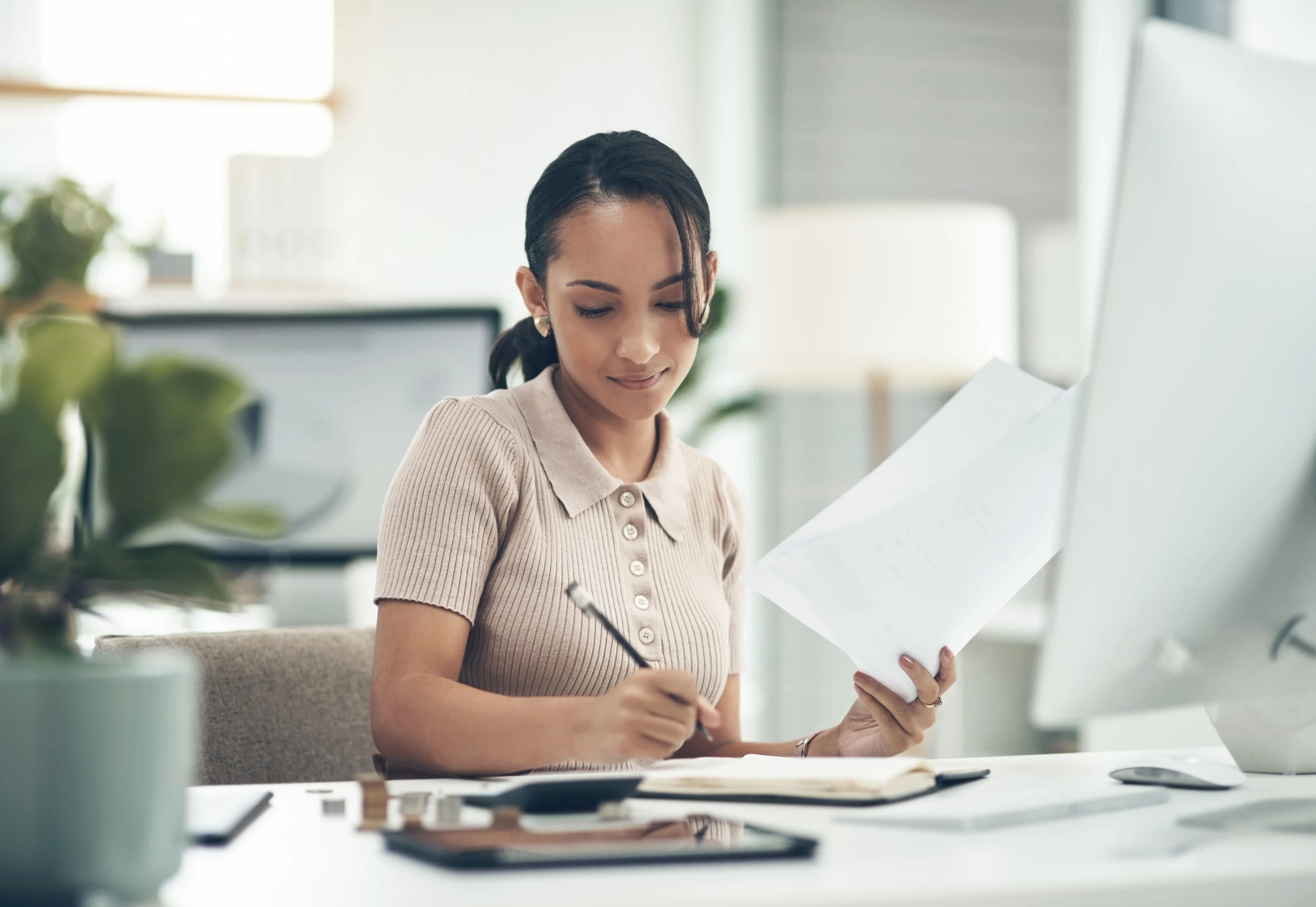 woman-taking-notes-desk