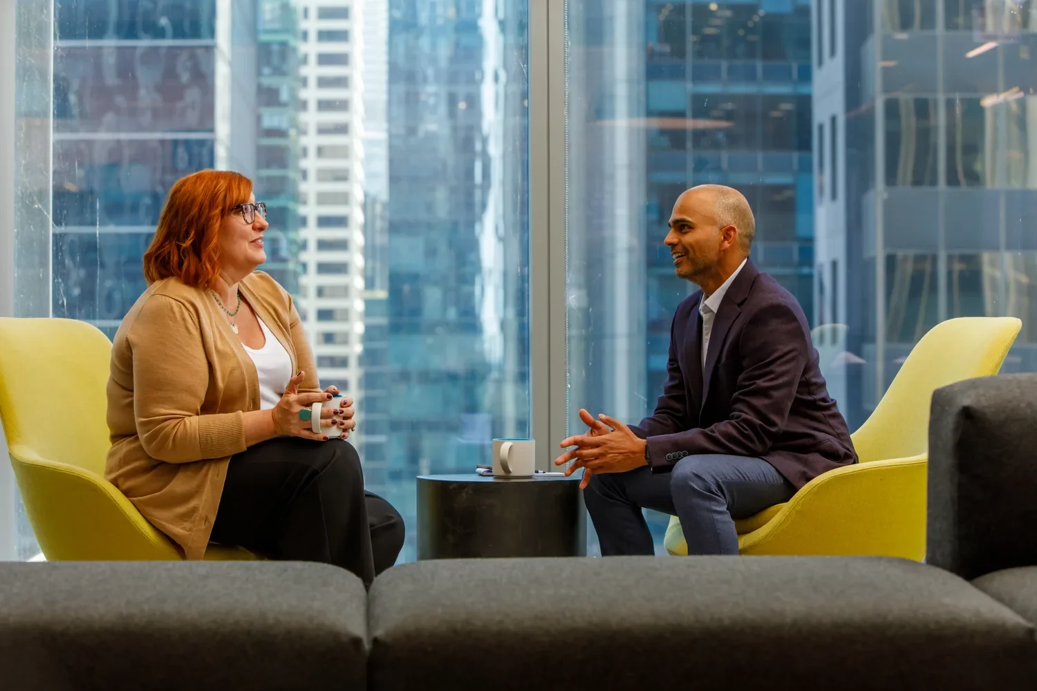 colleagues-talking-in-lounge-chairs