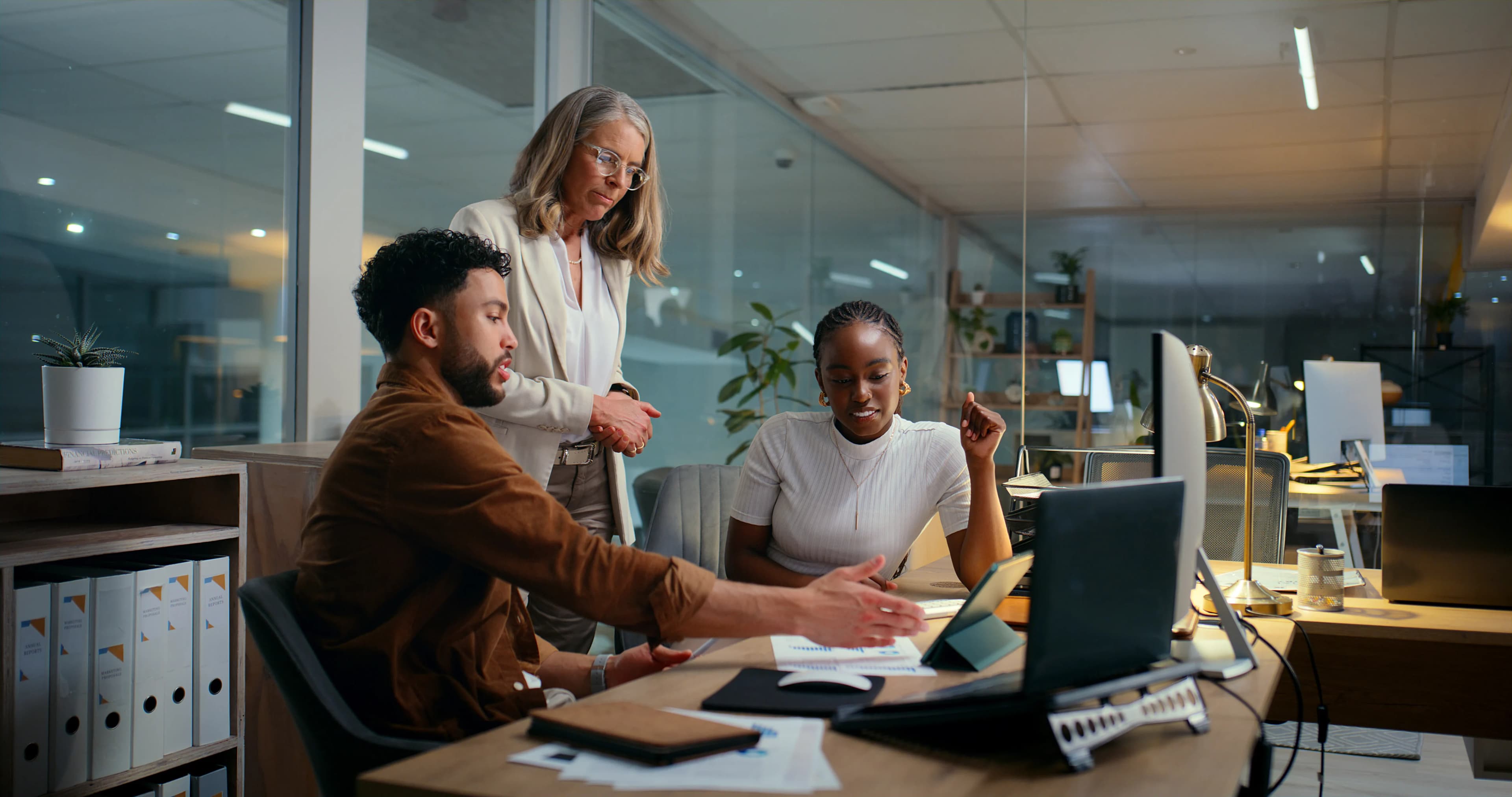 colleagues-reviewing-at-desk