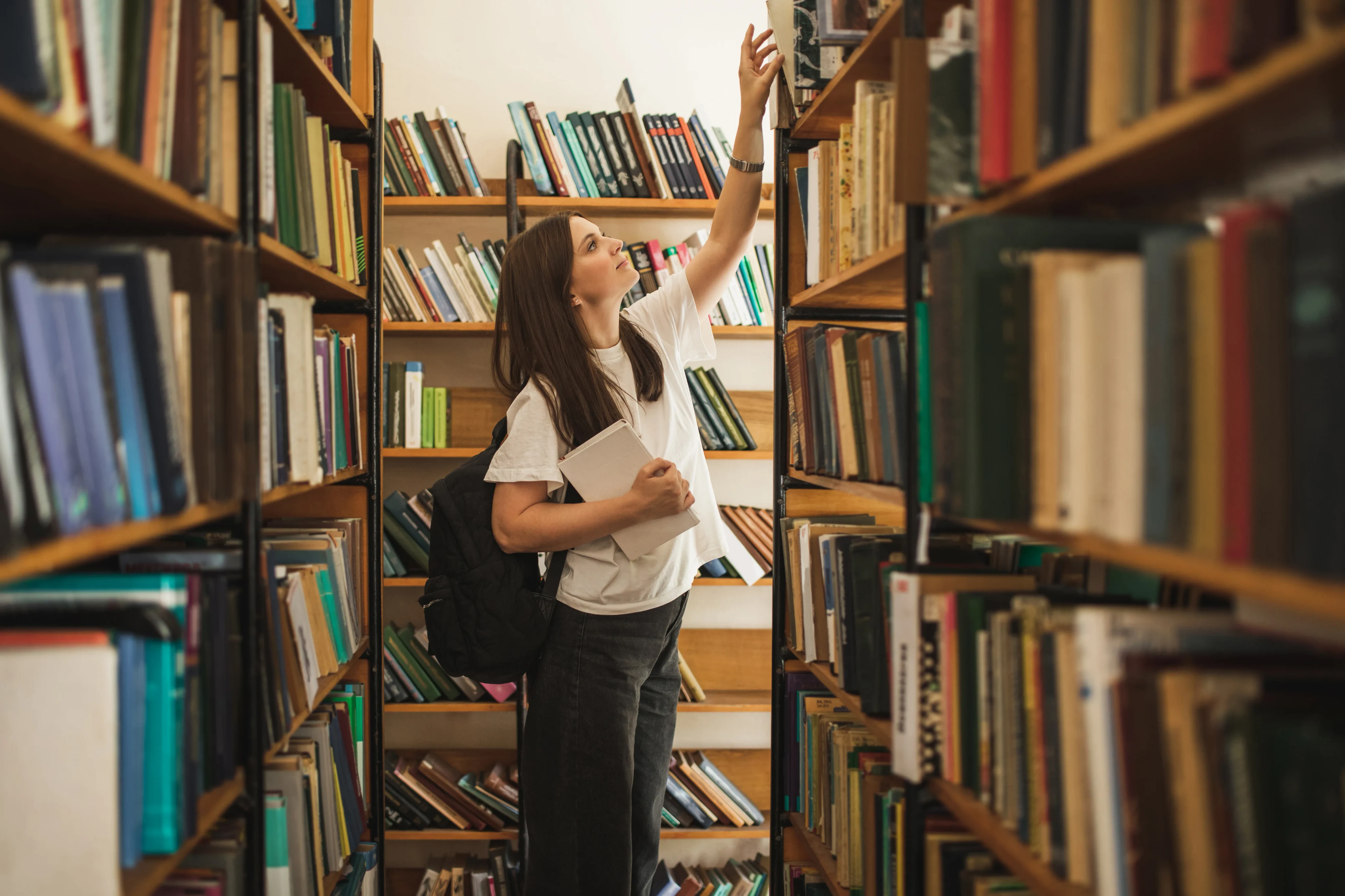 student-browsing-library-shelves